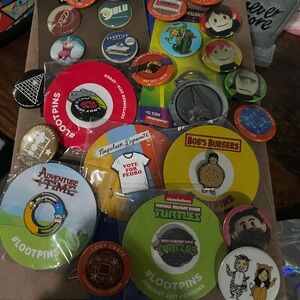 Colorful Assorted Pin Collection blue crate, pins, and buttons